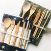 Portable bamboo utensil kit styled for an outdoor picnic, eco-friendly plastic-free travel dining