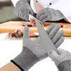 Gray kitchen gloves shown during meat slicing, with a close-up of a knife blade resting against a gloved palm
