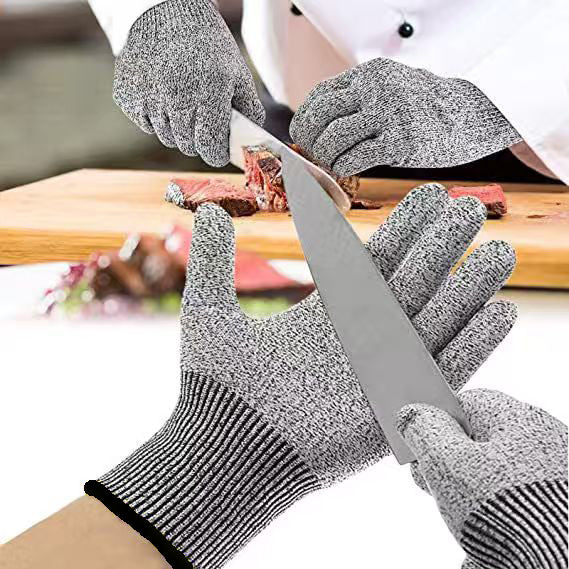 Gray kitchen gloves shown during meat slicing, with a close-up of a knife blade resting against a gloved palm
