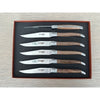 Overhead view of six walnut-handled steak knives in a fitted brown presentation box, with one knife turned to show its decorative spine