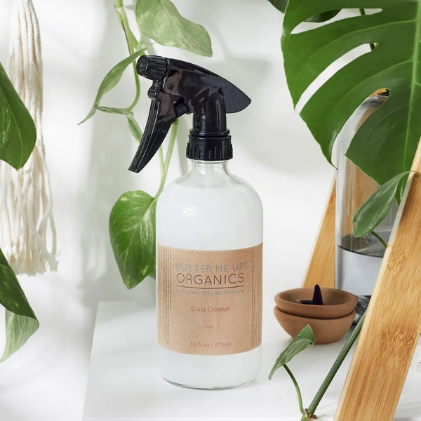 Glass cleaner styled on a modern kitchen counter with fresh limes, emphasizing plastic-free and zero-waste design