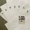 Close-up of Nana Mode fridge magnet holding 7 sheets of paper, showing high-performance magnetic strength