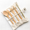 Set of bamboo cutlery including spoon, fork, and knife on a white background