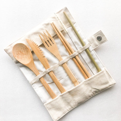 Set of bamboo cutlery including spoon, fork, and knife on a white background