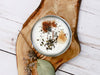 Close-up of ritual candle with dried herbs, citrine crystal, and wood wick, non-toxic soy wax