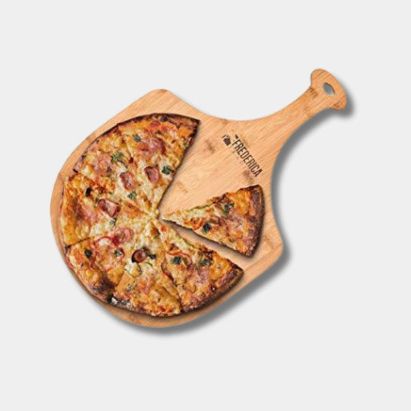 Wooden pizza peel with a pizza on a light gray background