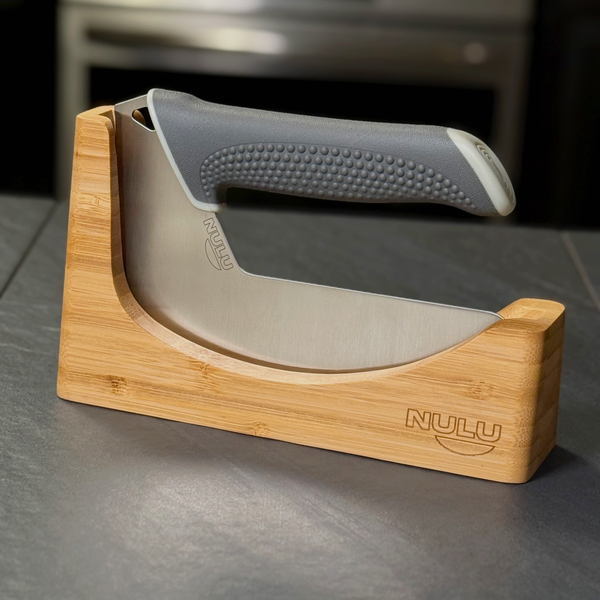 NULU bamboo knife dock holding a curved NULU knife on a dark kitchen countertop