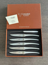 Laguiole en Aubrac six-piece matte steel steak knife set in an open presentation box with an authenticity certificate on the lid