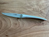 Side view of a Laguiole en Aubrac steak knife with a branded blade and curved matte stainless steel handle
