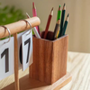Close-up of premium rubber, cherry, and ash wood grain texture on handcrafted desk organizer