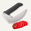 NULU curved stainless steel kitchen knife with a textured black handle beside sliced tomato on a white background