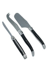 Three Laguiole en Aubrac cheese utensils with ebony handles, shown diagonally on a white background