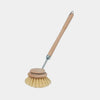 Dish brush with wooden handle and bristle head on a white background