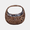 Half-moon wicker basket used as an indoor plant holder with integrated clear protective liner