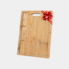 Close-up of 3 built-in ingredient compartments on bamboo cutting board for organized meal prep