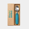 Blue-handled spoon in a Blauke branded box on a light gray background