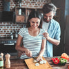 Man and woman preparing food together in a kitchen