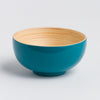 Teal ceramic bowl with wooden interior on a light gray background