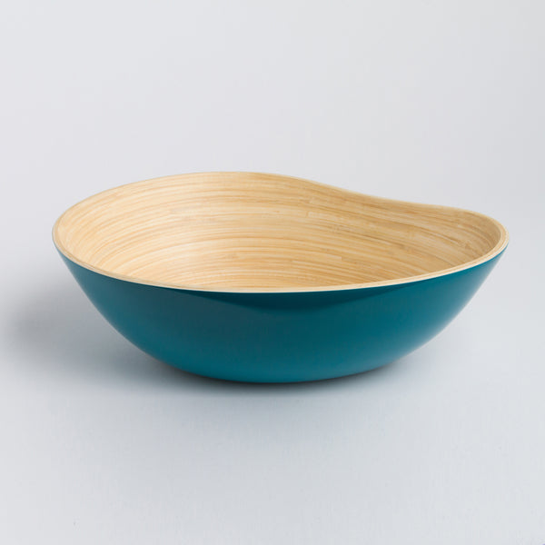 Bowl with teal bottom and wooden top on a light gray background