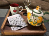 Acacia wood tray used as a coffee table organizer for book, mug, and tea pot, rustic home decor