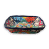 Front angled view of a rectangular Talavera serving dish showing its colorful floral interior and painted outer walls on white