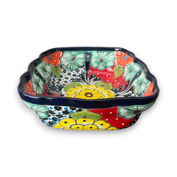 Colorful ceramic bowl with floral patterns on a white background