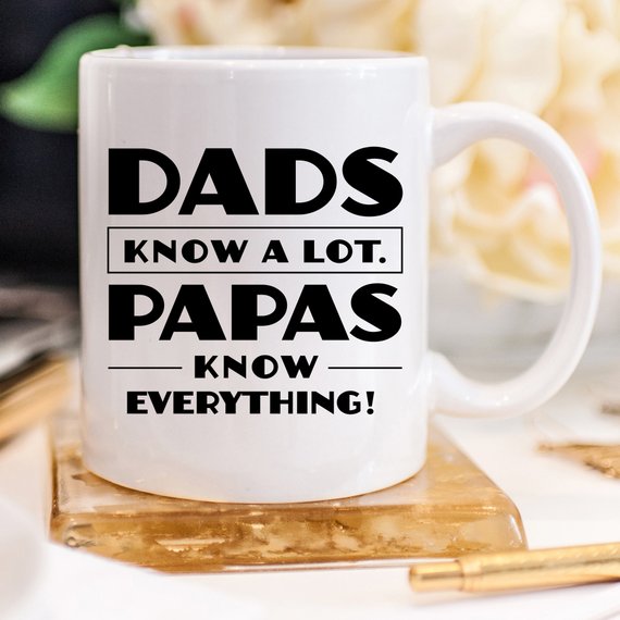 White mug with humorous text on a wooden coaster