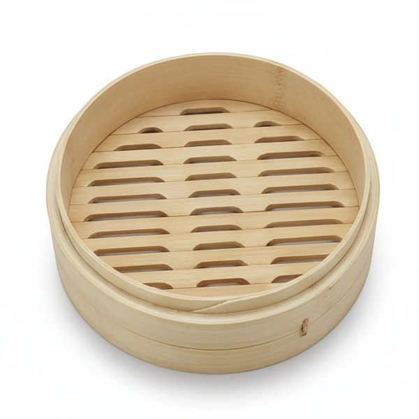 Empty round Alva bamboo steamer basket with a slatted base, shown at an angle on a white background