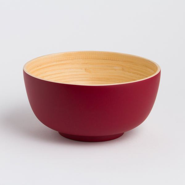 Red and beige ceramic bowl on a light gray background