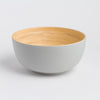 Bowl with gray exterior and wooden interior on a white background