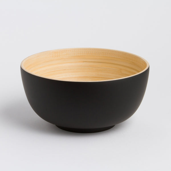 Black and beige ceramic bowl on a light gray background