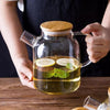 "Close up detail of stainless steel infuser inside glass teapot"
