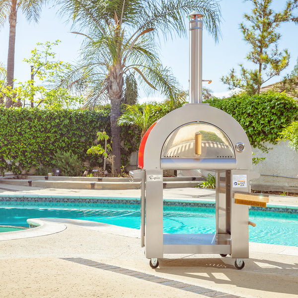 Empava PG06 wood-fired pizza oven on a luxury poolside patio.