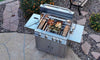 Overhead view of a KoKoMo cart grill cooking two chickens on a rotisserie in a garden patio