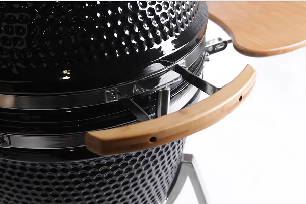 Close-up of the wooden lid handle and textured black ceramic body on a KoKoMo Kamado grill