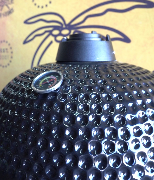 Close-up of the KoKoMo Kamado’s textured black ceramic lid, top airflow vent and built-in thermometer
