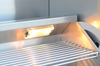 Close-up of an illuminated lamp above the KoKoMo grill warming rack