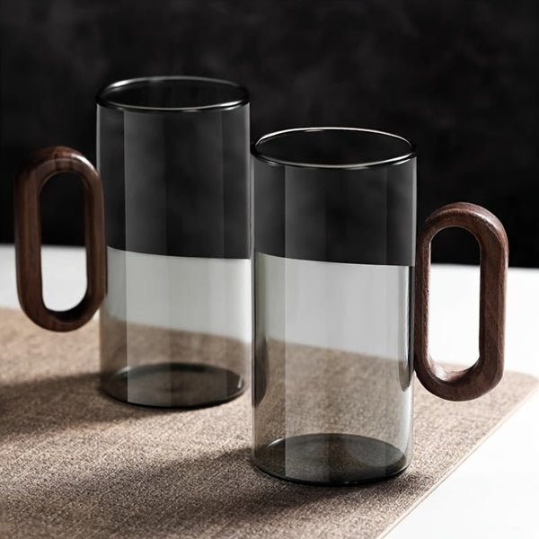 Ash-grey tinted glass mug with dark walnut handle, modern artisan drinkware