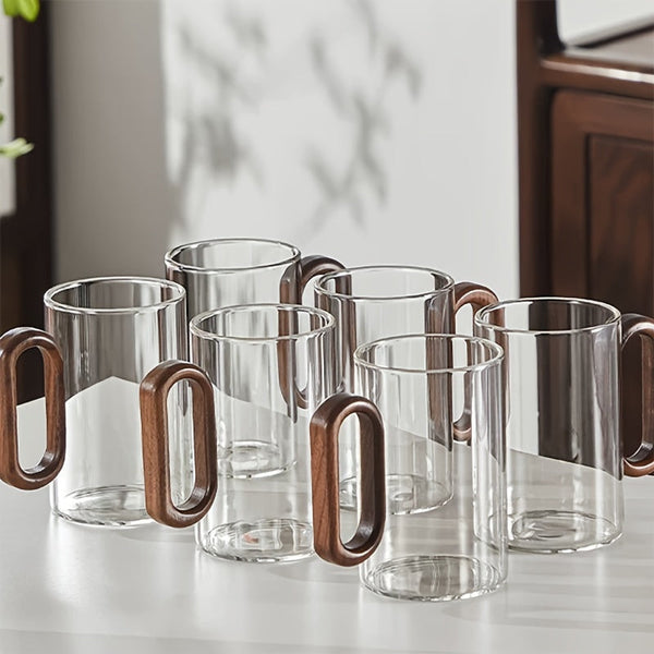 Close-up of ergonomic dark walnut wood handle on clear glass mug