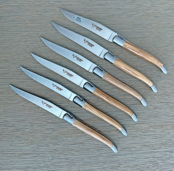 Six Laguiole en Aubrac steak knives with branded steel blades, olive wood handles and stainless steel bolsters