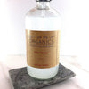 Glass bottle of Butter Me Up Organics Glass Cleaner on a marble coaster