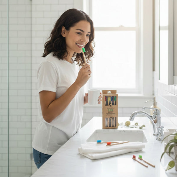 Four natural bamboo toothbrushes neatly arranged on a minimalist bathroom shelf