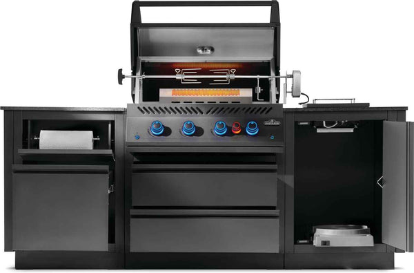 Front view of OASIS kitchen with rotisserie spit, glowing rear burner, paper towel holder and open storage