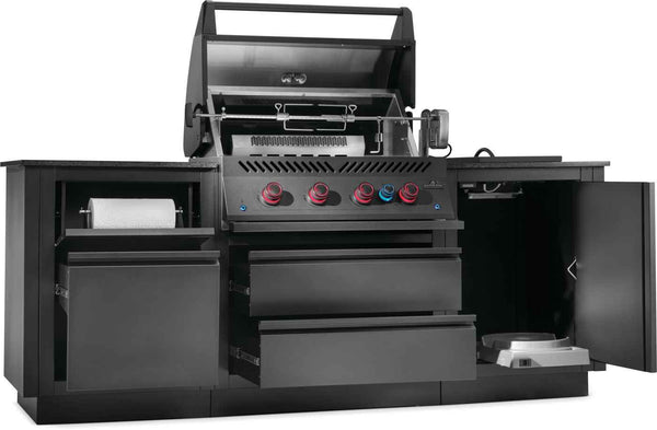 Angled view of OASIS kitchen with grill lid raised, rotisserie, open storage drawers and propane cabinet