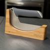 NULU bamboo knife dock holding a curved NULU knife on a dark kitchen countertop