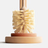 Close-up of stiff natural sisal bristles and sustainable wood handle of plastic-free toilet brush