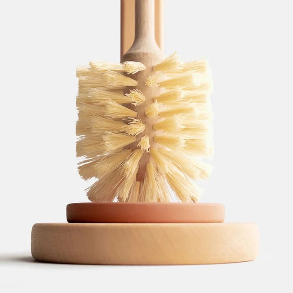 Close-up of stiff natural sisal bristles and sustainable wood handle of plastic-free toilet brush