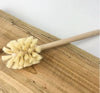 Minimalist plastic-free toilet brush styled in a modern bathroom, sustainable and zero-waste cleaning accessory