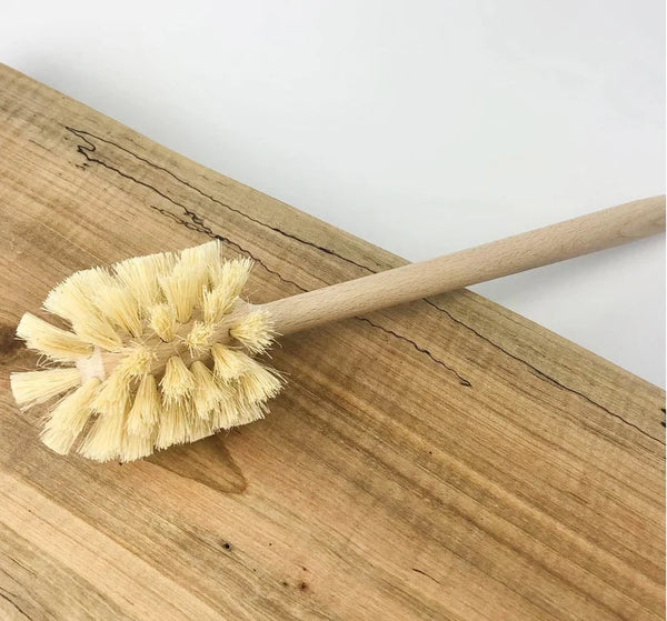 Minimalist plastic-free toilet brush styled in a modern bathroom, sustainable and zero-waste cleaning accessory