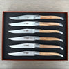 Six Laguiole en Aubrac olive wood steak and table knives arranged in a brown presentation box with a fitted black insert